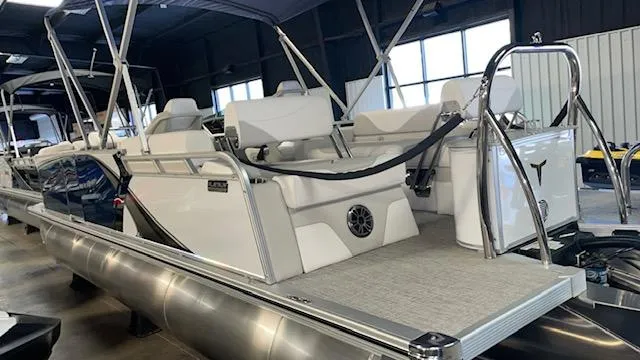 Slide: The Image of 2025 Tahoe LTZ 2385 QLS pontoon boat with spacious seating and modern design in showroom. - 4