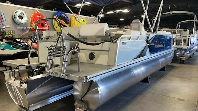 Slide: The Image of 2025 Tahoe LTZ 2385 QLS pontoon boat in showroom, featuring sleek design and modern amenities. - 5