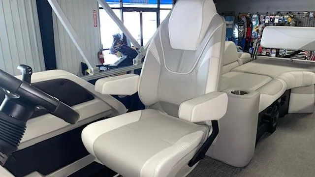 Slide: The Image of 2025 Tahoe LTZ 2385 QLS boat interior with modern seating and steering console. - 6