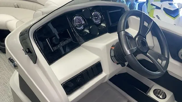 Slide: The Image of 2025 Tahoe LTZ 2385 QLS boat dashboard with steering wheel and gauges. - 7