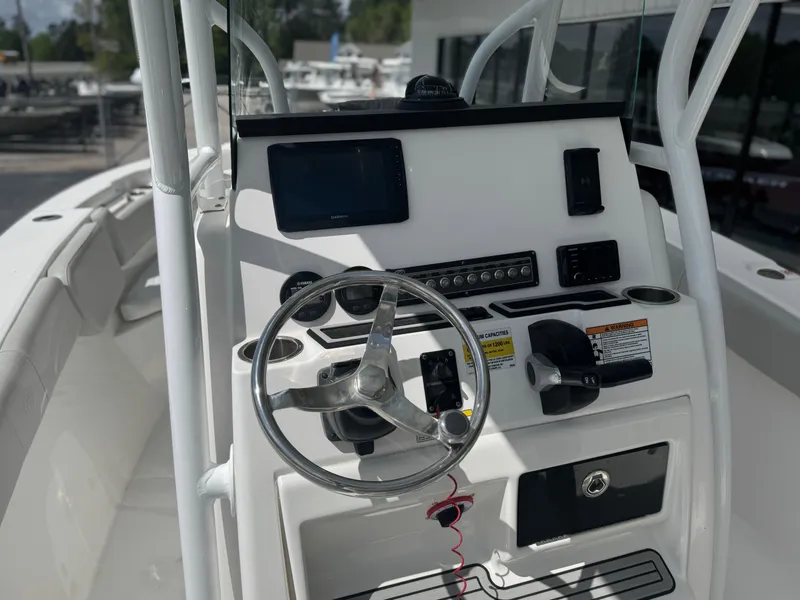 Slide: The Image of 2021 Sea Fox 228 Commander boat console with steering wheel and navigation controls. - 11