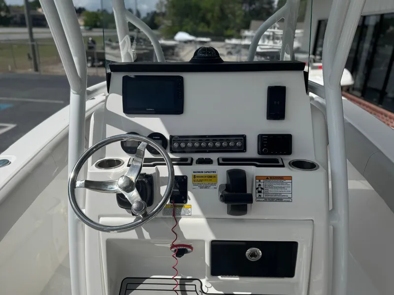 Slide: The Image of 2021 Sea Fox 228 Commander boat console with steering wheel and navigation controls. - 6