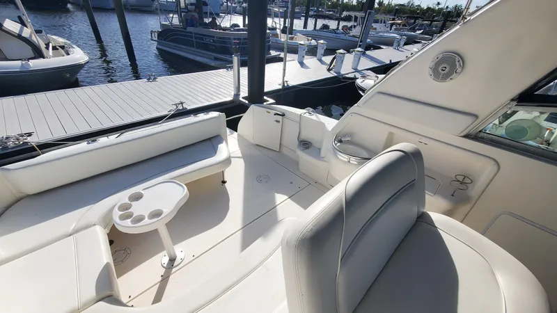 Slide: The Image of 2001 Sea Ray 310 Sundancer boat interior with seating and table, docked at marina. - 10