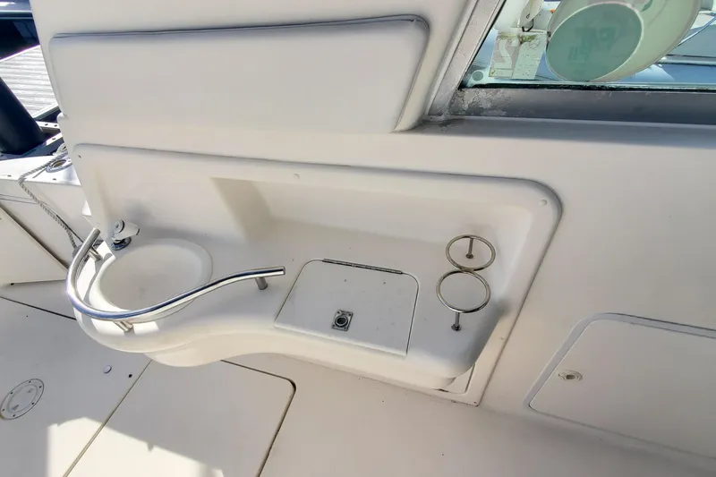 Slide: The Image of 2001 Sea Ray 310 Sundancer cockpit sink and storage area. - 12