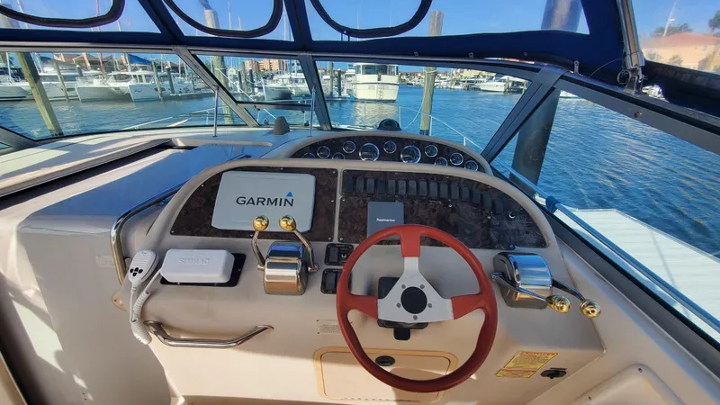 Slide: The Image of Cockpit of 2001 Sea Ray 310 Sundancer with Garmin navigation system, docked at marina. - 13