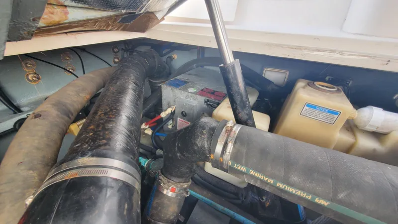 Slide: The Image of Engine compartment of a 2001 Sea Ray 310 Sundancer boat, showing hoses and components. - 16