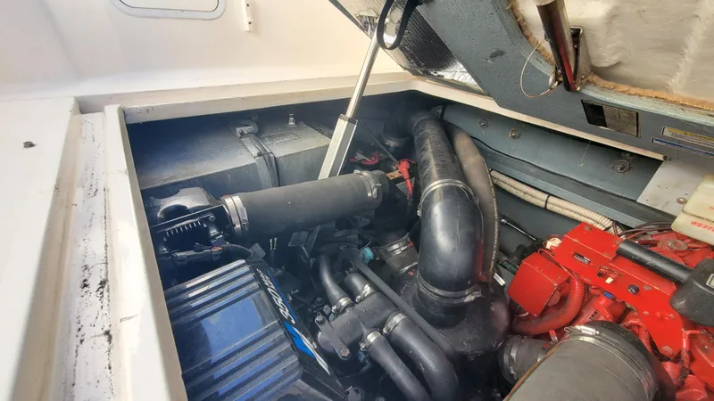 Slide: The Image of Engine compartment of a 2001 Sea Ray 310 Sundancer boat, showcasing mechanical components. - 21