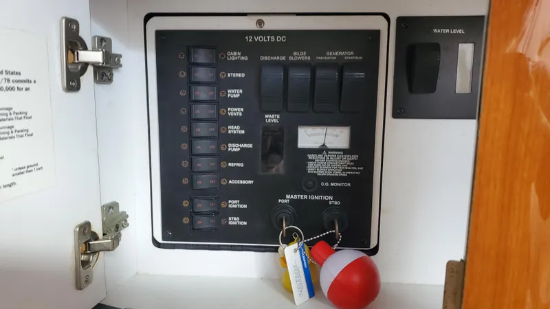 Slide: The Image of Electrical panel inside a 2001 Sea Ray 310 Sundancer boat cabinet. - 29