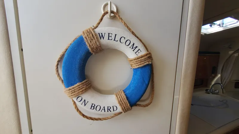 Slide: The Image of "Welcome on board" life ring on 2001 Sea Ray 310 Sundancer yacht. - 36