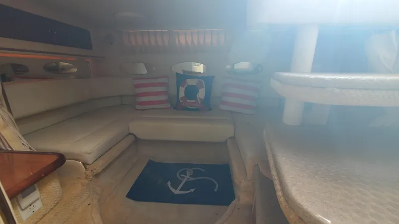 Slide: The Image of Interior of 2001 Sea Ray 310 Sundancer with cozy seating and nautical decor. - 41