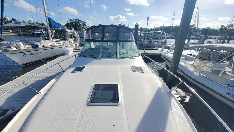 Slide: The Image of 2001 Sea Ray 310 Sundancer docked at marina under clear blue sky. - 45
