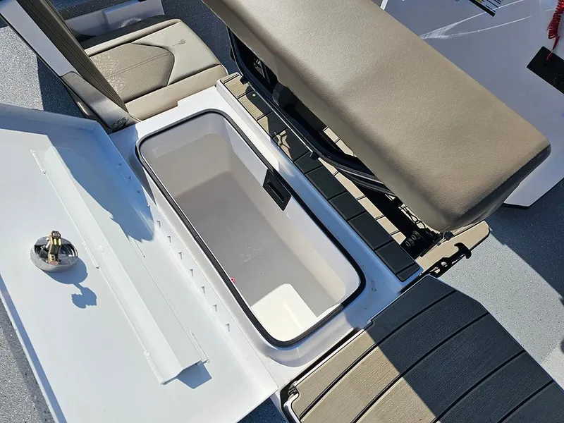 Slide: The Image of 2025 Vexus ACX 2000 boat interior with open storage compartment and cushioned seating. - 13