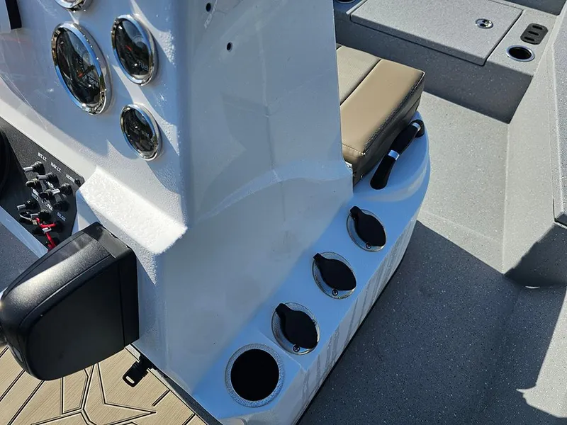 Slide: The Image of 2025 Vexus ACX 2000 boat console with gauges and cup holders. - 15