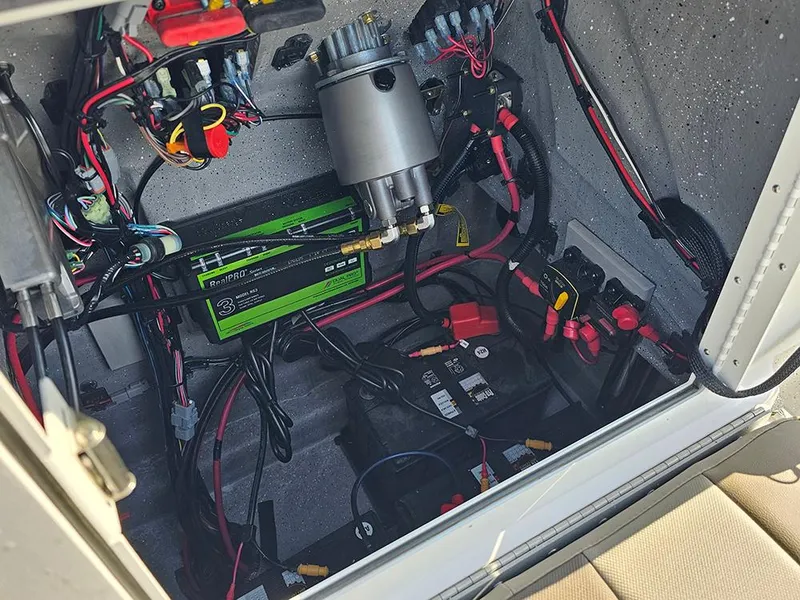 Slide: The Image of Electrical compartment of 2025 Vexus ACX 2000 boat, showcasing wiring and battery setup. - 18