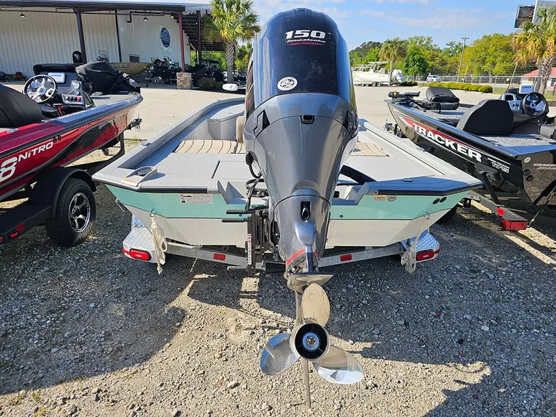 Slide: The Image of 2025 Vexus ACX 2000 boat with 150 HP engine, parked outdoors. - 6