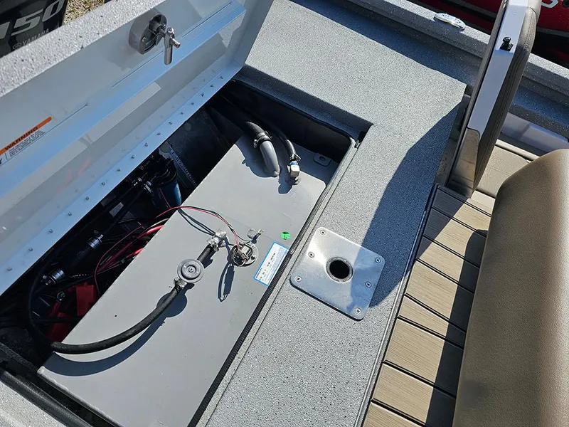 Slide: The Image of 2025 Vexus ACX 2000 boat battery compartment with wiring and seating area. - 9