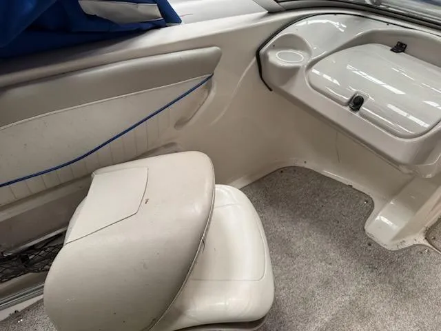 Slide: The Image of 2006 Glastron MX 195 boat interior with white seating and storage compartment. - 5