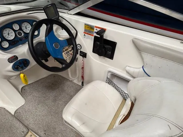 Slide: The Image of 2006 Glastron MX 195 boat interior with steering wheel and dashboard controls. - 6