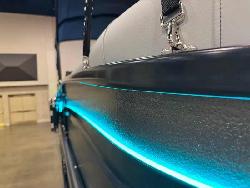 Slide: The Image of 2025 Premier 250 Solaris Rear Social boat with sleek blue LED accent lighting. - 12