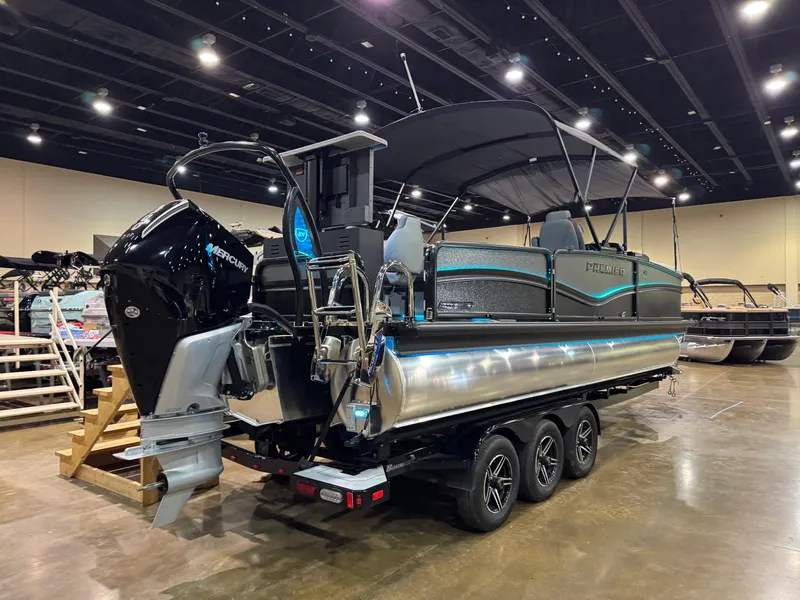 Slide: The Image of 2025 Premier 250 Solaris Rear Social pontoon boat displayed indoors with modern design and powerful engine. - 13