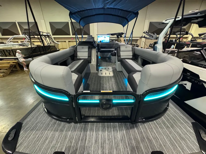 Slide: The Image of 2025 Premier 250 Solaris Rear Social pontoon boat with modern seating and ambient lighting. - 18