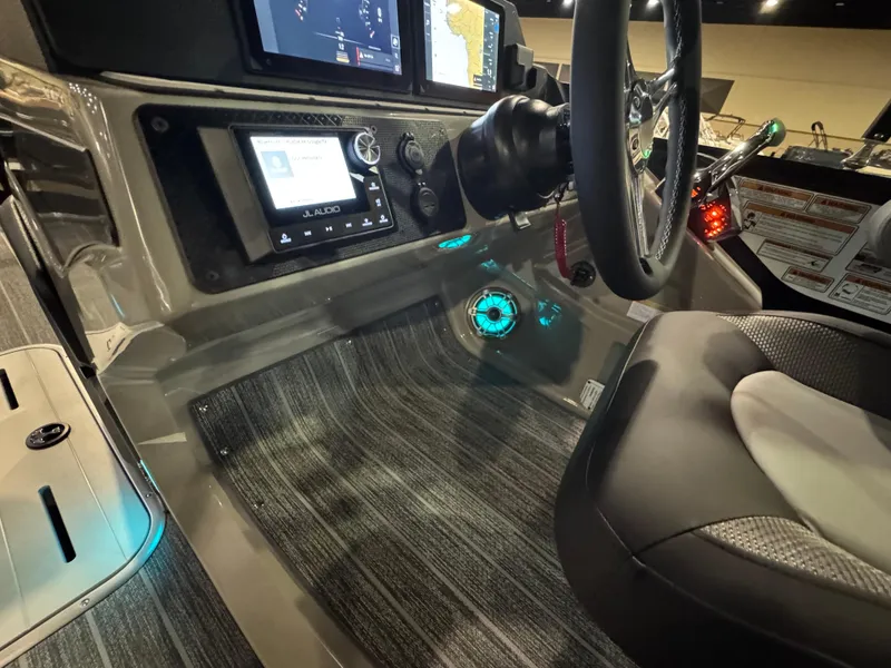 Slide: The Image of 2025 Premier 250 Solaris Rear Social boat dashboard with modern controls and illuminated features. - 30