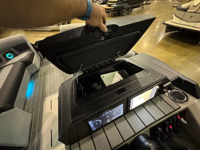 Slide: The Image of Open storage compartment on 2025 Premier 250 Solaris Rear Social boat dashboard. - 31