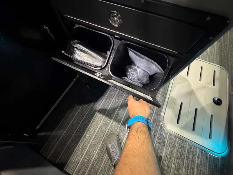 Slide: The Image of Interior storage compartment of 2025 Premier 250 Solaris Rear Social boat, with carpeted flooring. - 32