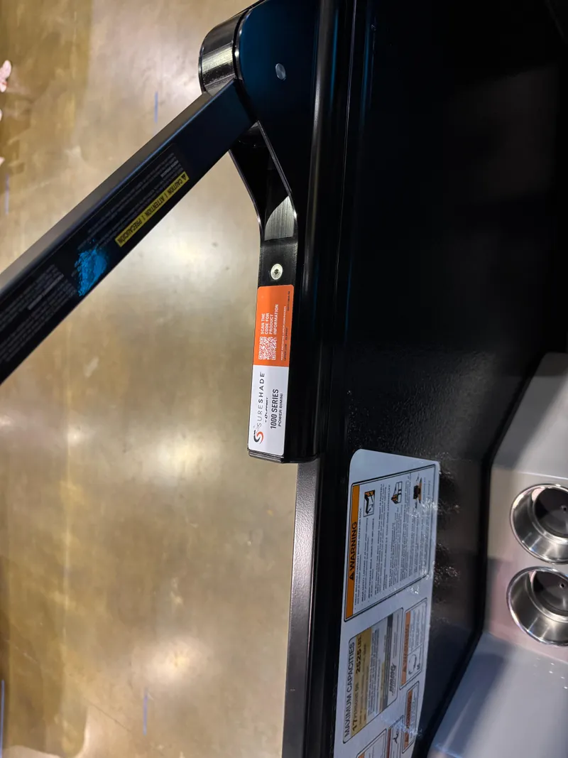 Slide: The Image of 2025 Premier 250 Solaris Rear Social boat detail with safety labels and cup holders. - 36