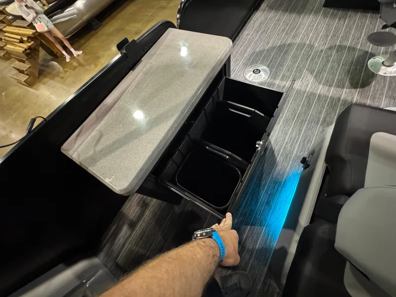 Slide: The Image of 2025 Premier 250 Solaris Rear Social boat interior with storage compartment and modern design. - 37