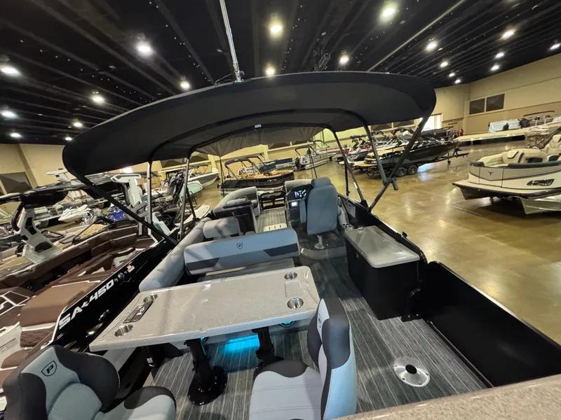 Slide: The Image of 2025 Premier 250 Solaris Rear Social pontoon boat interior at a showroom display. - 43