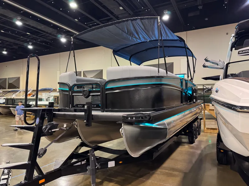 Slide: The Image of 2025 Premier 250 Solaris Rear Social pontoon boat on display indoors. - 5