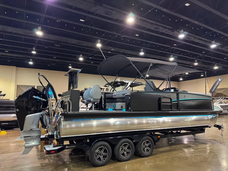 Slide: The Image of 2025 Premier 250 Solaris Rear Social pontoon boat on display indoors. - 9
