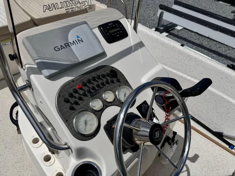 Slide: The Image of 2019 Carolina Skiff 218 DLV boat console with Garmin navigation system and steering wheel. - 12