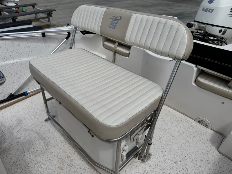 Slide: The Image of 2019 Carolina Skiff 218 DLV boat seat with white cushioned bench and backrest. - 15
