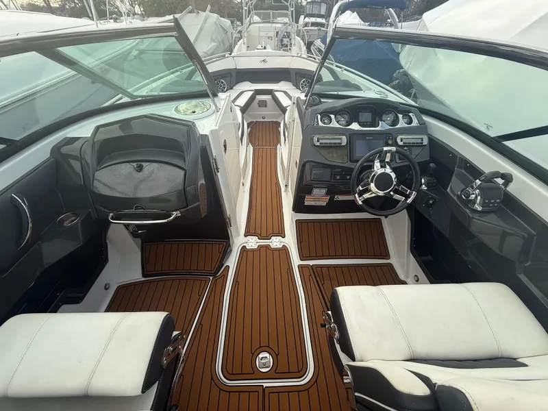 Slide: The Image of 2018 Monterey 298 Super Sport boat interior with sleek design and wood accents. - 10