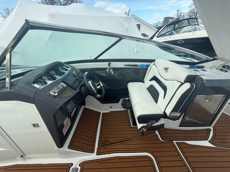 Slide: The Image of 2018 Monterey 298 Super Sport boat interior with sleek dashboard and comfortable seating. - 11