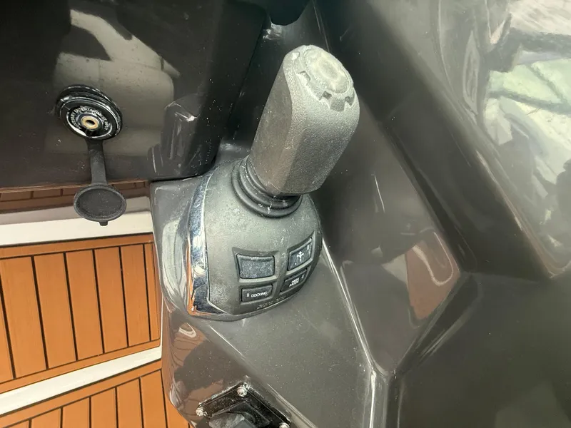 Slide: The Image of Joystick control on 2018 Monterey 298 Super Sport boat, featuring sleek design and wood flooring. - 14