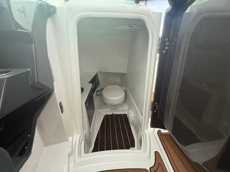 Slide: The Image of 2018 Monterey 298 Super Sport boat interior with compact bathroom and toilet. - 20
