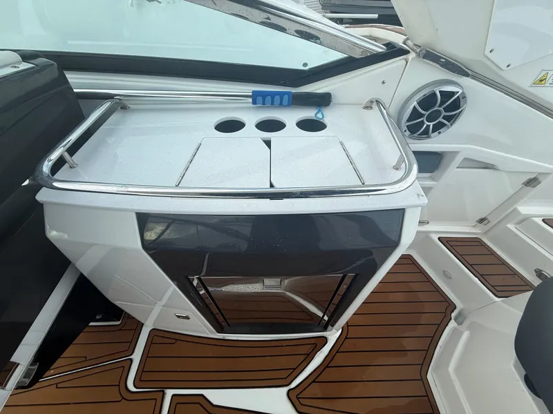Slide: The Image of 2018 Monterey 298 Super Sport boat interior with sleek design and wooden flooring. - 21