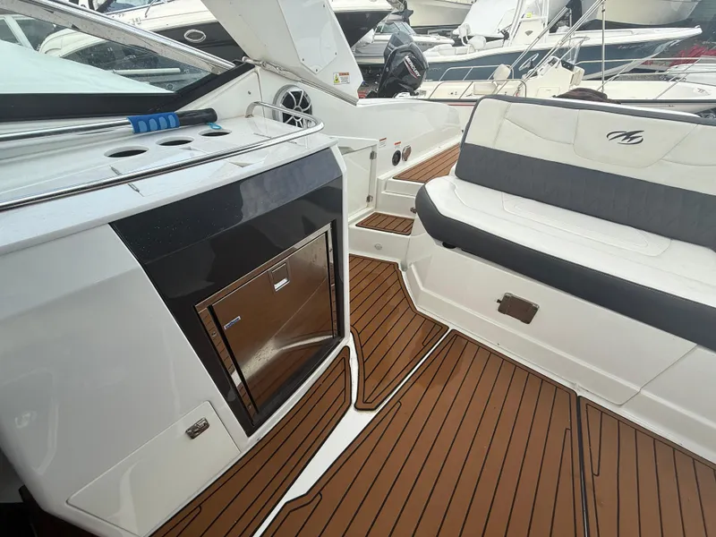 Slide: The Image of 2018 Monterey 298 Super Sport boat interior with teak flooring and seating area. - 25