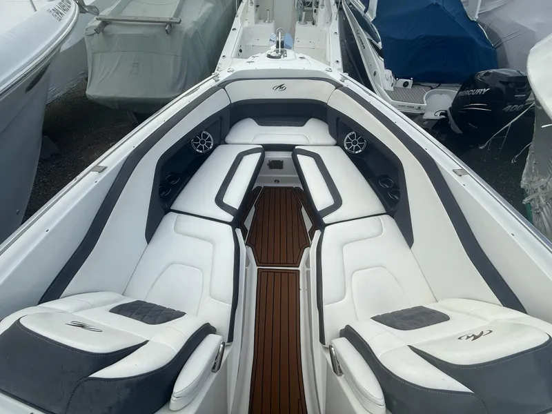 Slide: The Image of 2018 Monterey 298 Super Sport boat interior with white seating and wood flooring. - 3