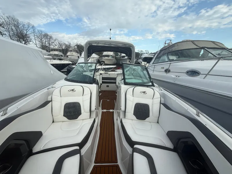 Slide: The Image of 2018 Monterey 298 Super Sport boat interior with white seating and wooden flooring. - 7