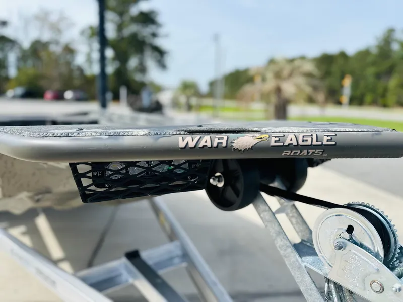 Slide: The Image of 2025 War Eagle 548LDV boat on trailer, showcasing brand logo and design details. - 4