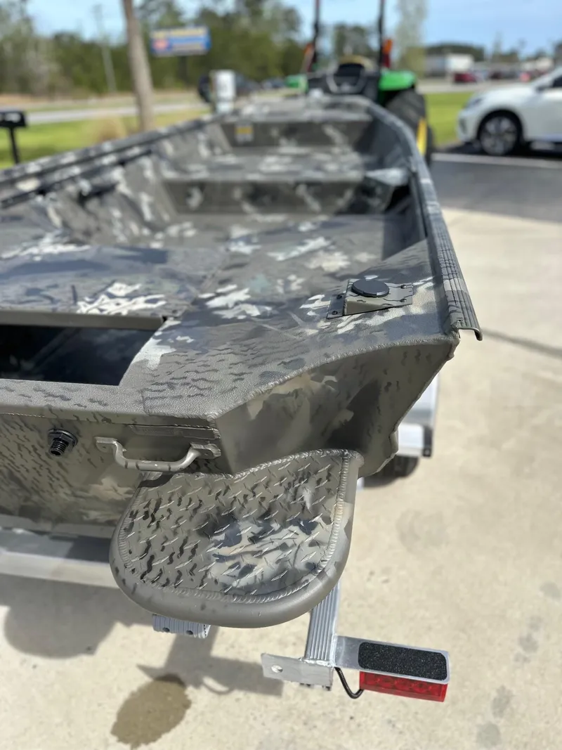 Slide: The Image of 2025 War Eagle 548LDV boat with camouflage design on a trailer. - 5