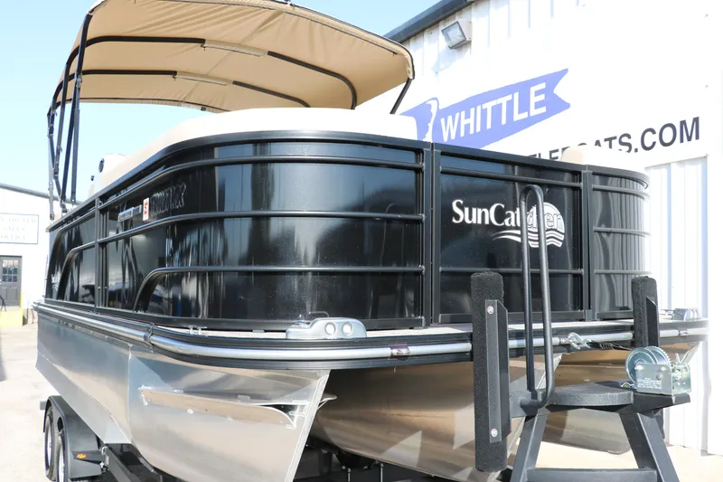 Slide: The Image of 2024 SunCatcher Select 320 RC pontoon boat with canopy, displayed at dealership. - 10