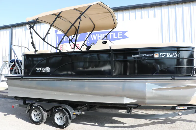 Slide: The Image of 2024 SunCatcher Select 320 RC pontoon boat on trailer, featuring a beige canopy. - 13