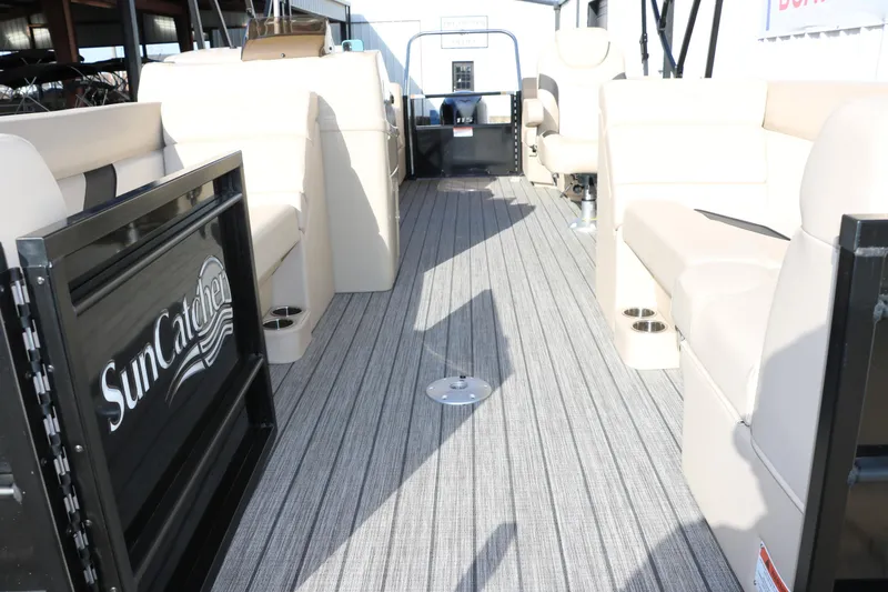Slide: The Image of 2024 SunCatcher Select 320 RC pontoon boat interior with beige seating and striped flooring. - 19