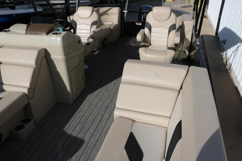 Slide: The Image of 2024 SunCatcher Select 320 RC boat interior with beige seating and steering console. - 20