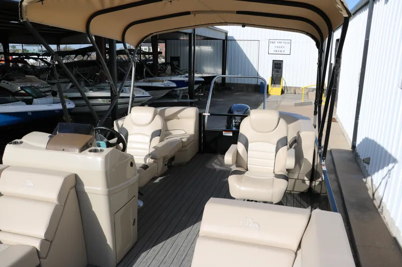 Slide: The Image of 2024 SunCatcher Select 320 RC pontoon boat with beige seating and canopy in a marina. - 21